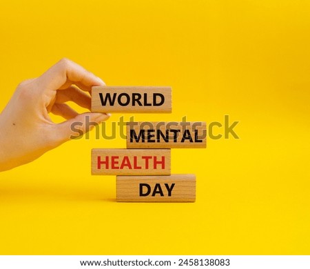World Mental Health Day symbol. Wooden blocks with words World Mental Health Day. Businessman hand. Beautiful yellow background. Health concept. Copy space.