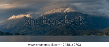 Harrison Lake located in the Fraser Valley of British Columbia with a dusting of snow in the higher elevations. This is a mountain in the Lillooet Ranges of southwestern British Columbia, Canada Royalty-Free Stock Photo #2458162703