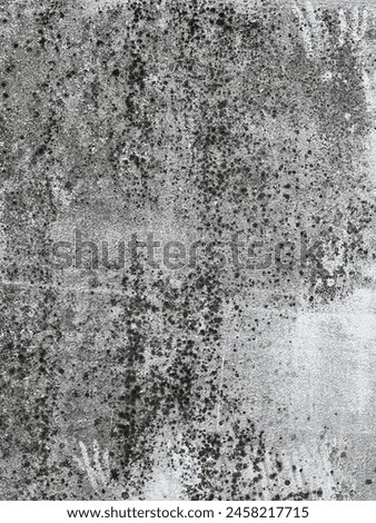 a photography of a black and white photo of a wall with a lot of dirt.