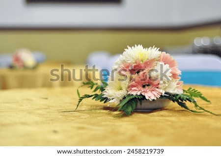 a beautiful flower bouquet on the guest table at a wedding