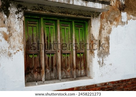 Old wooden windows on mossy walls Royalty-Free Stock Photo #2458221273
