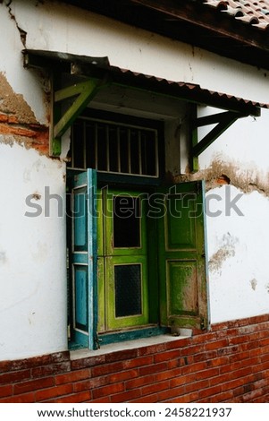Old wooden windows on mossy walls Royalty-Free Stock Photo #2458221937