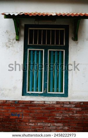 Old wooden windows on mossy walls Royalty-Free Stock Photo #2458222973