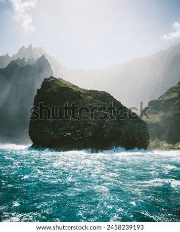 Along the beautiful Napali coastline with misty air. Taken from a catamaran. Royalty-Free Stock Photo #2458239193