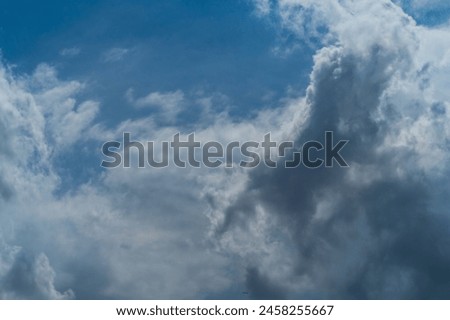 Dense, heavy clouds with rain potential move across the sky. Precipitation due to a decrease in atmospheric pressure to the point of dew. Royalty-Free Stock Photo #2458255667