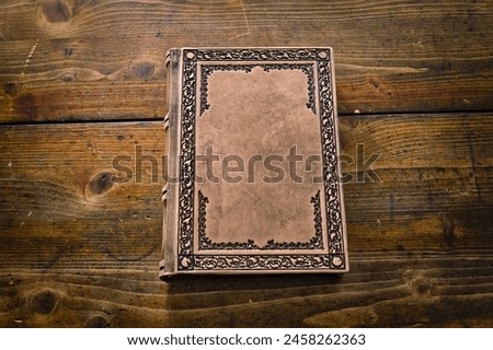 Aged beige leather journal lay down to wooden table