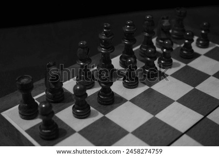 A black and white image of a complete chessboard with all its pieces.