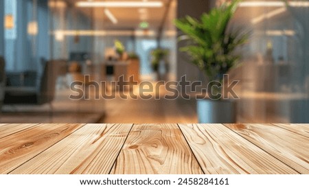 Blurred contemporary hotel lobby setting behind a wooden table, designed to enhance the display of advertising products and presentations on the table.