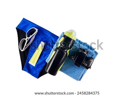 Male accessories for swimming in pool isolated on white background. Adventure-ready kit: Men's beach set includes camera, towel, flask, glasses, and sunscreen.