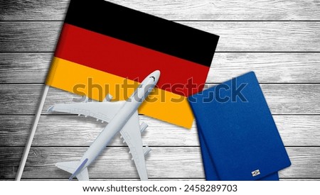 Flag of Germany with passport and toy airplane. Flight travel concept.
