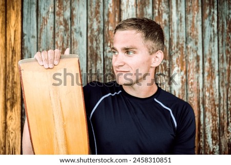 Portrat of young canoeist holding paddle. Concept of canoeing as dynamic and adventurous sport. Royalty-Free Stock Photo #2458310851