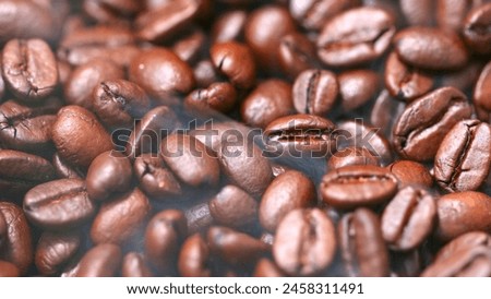 The coffee beans, with their unique features and the steam, create a cozy atmosphere. Royalty-Free Stock Photo #2458311491
