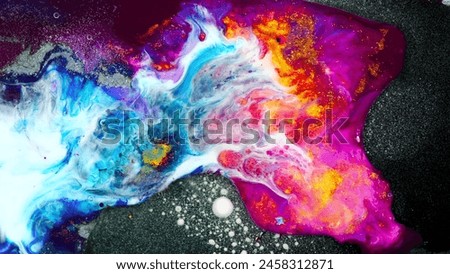 The painting depicts a vibrant explosion of colors, with a mix of blue, red, and yellow, against a dark background. Royalty-Free Stock Photo #2458312871
