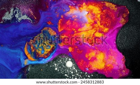 The painting depicts a vibrant, swirling galaxy with a mix of blue, orange, and yellow hues. Royalty-Free Stock Photo #2458312883