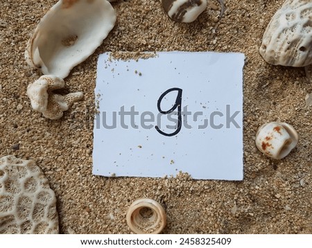 Number nine writting on beach sand background.