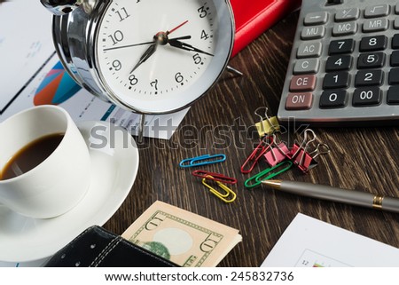 Close up of calculator documents and other staff on office table