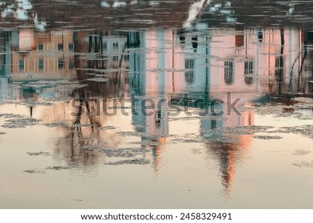 Reflection of the Epiphany Cathedral and the pink morning sky in the water of the Western Dvina River in February. Polotsk, Belarus.