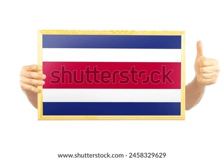 Hands holding a frame with Costa Rica flag, two hands and thumb up, celebration or victory concept, independence day idea, approvement or success in Costa Rica