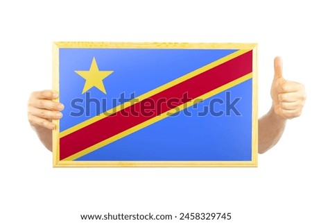 Hands holding a frame with Congo Democratic Republic flag, two hands and thumb up, independence day idea, approvement or success in Congo Democratic Republic, celebration or victory concept
