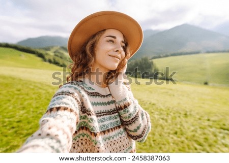 Beautiful young woman doing selfie in the nature. Blogging, communication, travel, tourism, nature, active life.