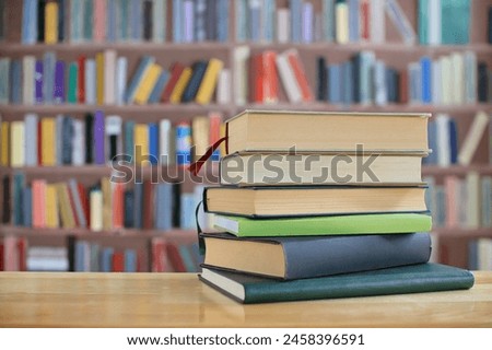 Stack of books on the table in library, education