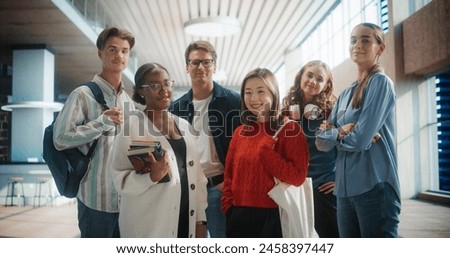 Diverse Group of Students Standing Together in Modern University Hallway. Multiethnic Young Adults with Books and Backpacks, Smiling and Posing for a Group Photo in a Brightly Lit Educational Setting