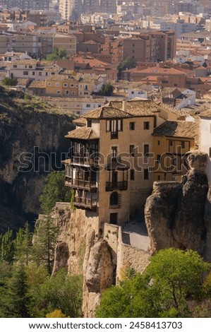 The city of Cuenca, Spain is depicted, showcasing medieval houses in the center juxtaposed with modern buildings Royalty-Free Stock Photo #2458413703
