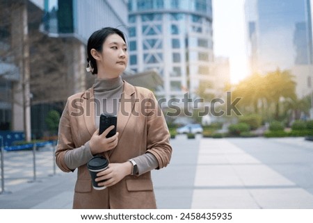Professional Woman Multitasking in Urban Setting