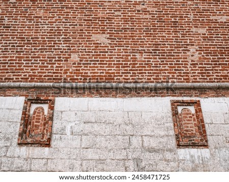 Two tightly bricked loopholes in the fortress. Abstract composition Royalty-Free Stock Photo #2458471725