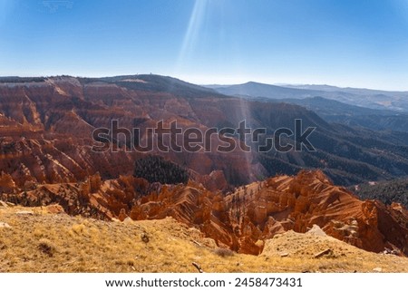 Cedar Breaks National Monument in Utah. A natural amphitheater filled with hoodoos, windows, canyons, spires, walls, and steep cliffs. A veiw from the canyon rim. Brian Head Peak in distance.  Royalty-Free Stock Photo #2458473431