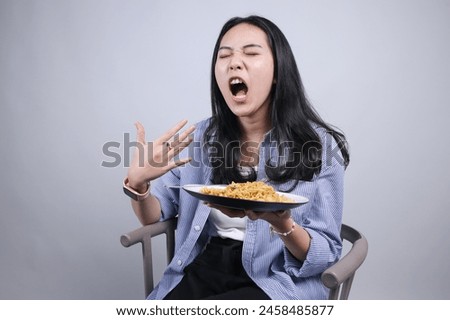 Young Asian Woman Opening Mouth Showing Spicy While Eating Noodles Isolated On White Background