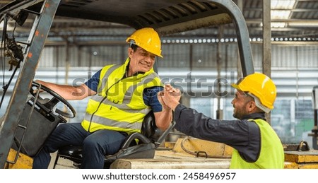 greeting by handshake touch fist and elbow of two engineer supervisor partnership in old factory. foreman greeting friend for good friendship colleague laborer in teamwork factory. Royalty-Free Stock Photo #2458496957