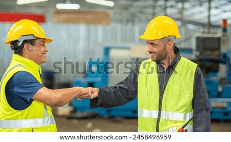 greeting by handshake touch fist and elbow of two engineer supervisor partnership in old factory. foreman greeting friend for good friendship colleague laborer in teamwork factory. Royalty-Free Stock Photo #2458496959