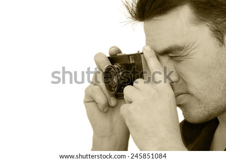 man photographs the old camera