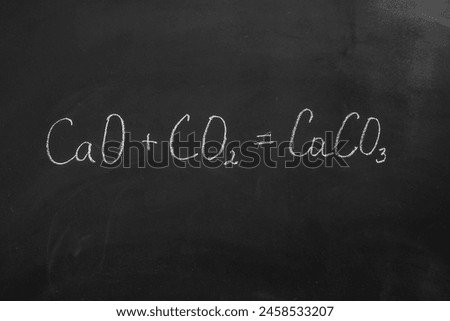 Chemical reaction formula written with chalk on a blackboard