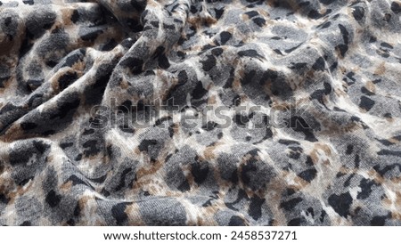 Rayon cotton fabric with leopard print. Fabric texture. Animal print.