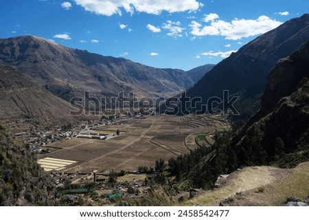 Landscape composed of mountains, urban area of the city of Pisac and plantation fields in the Sacred Valley. Royalty-Free Stock Photo #2458542477
