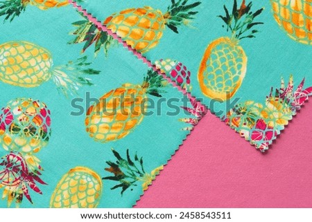 corners of fabric samplers with pineapple prints on pink paper