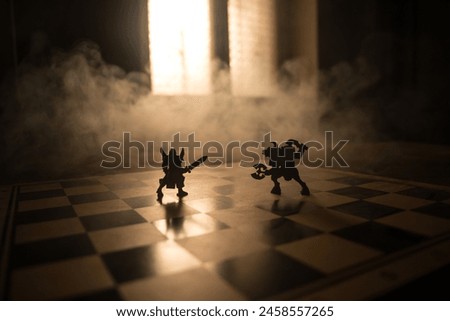 Medieval battle scene with cavalry and infantry on chessboard. Chess board game concept of business ideas and competition and strategy ideas Chess figures on a dark background with smoke and fog. Royalty-Free Stock Photo #2458557265