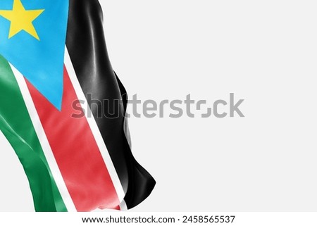 National flag of South Sudan flutters in the wind. Wavy South Sudan Flag. Close-up front view.