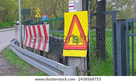 Road Sign Warning About Wildlife Reptile Amphibian Crossing Road during During Breeding Season Royalty-Free Stock Photo #2458568753
