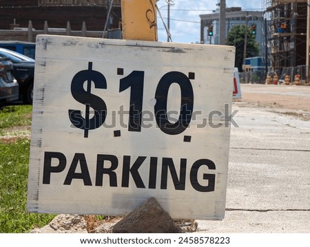 A Paid Parking Sign Indicating Price Gouging During an Event 