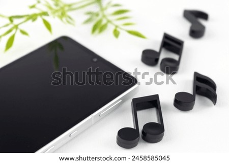 Smartphone and musical notes. image of listening to music