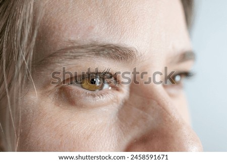 intense hazel eyes close-up, girl 25-30 years old, human eye looking to side, vision examination, myopia, eye fatigue, color perception Royalty-Free Stock Photo #2458591671