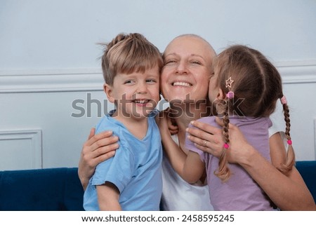 A picture of familial love with a bald woman cancer fighter at the center, receiving warm hugs from the young children around her on a cozy couch