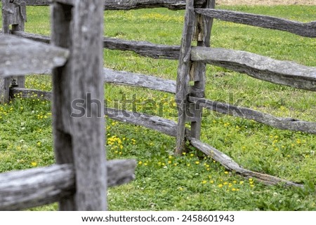 Rustic wooden fence with signs of distress by weather