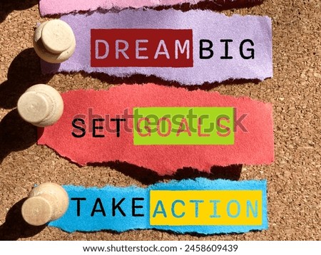 Inspirational motivational concept - dream big set goals take action text on adhesive note background. Stock photo.