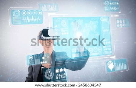 Skilled business woman pointing at financial data while wearing VR glasses. Professional project manager looking at marketing strategy while connecting with metaverse and visual reality. Contraption.