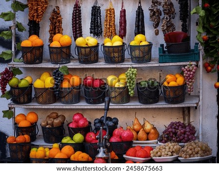 fresh fruits and traditional Georgian Churchkhela, each item meticulously placed to showcase its vibrant color and form.image highlights the visual appeal and cultural significance of market