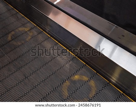 Step signs on an escalator in a mall.